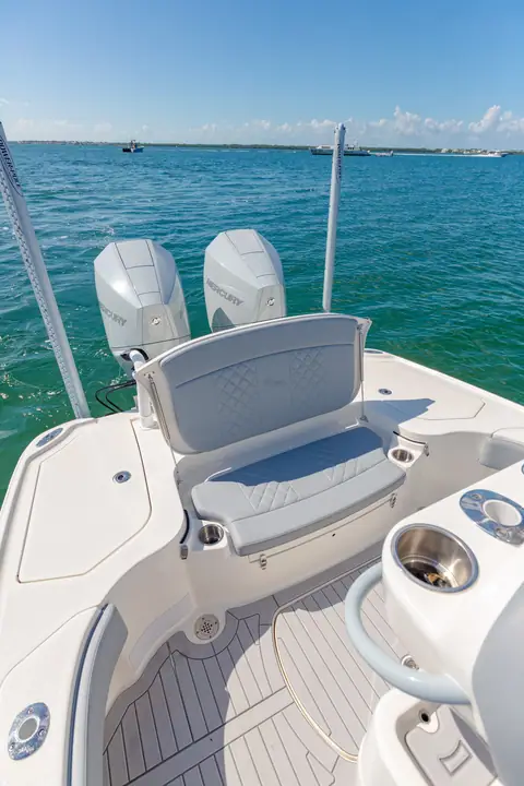 SeaVee 270Z cockpit with folding aft seat, teak style decking and twin outboards beyond
