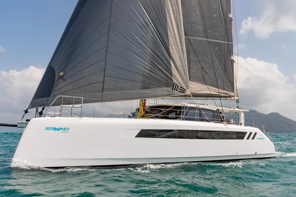 Seawind 1370 catamaran sailing on a reach under a dark mainsail and jib