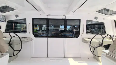 Seawind 1370 aft cockpit with twin helm wheels and the folding saloon doors