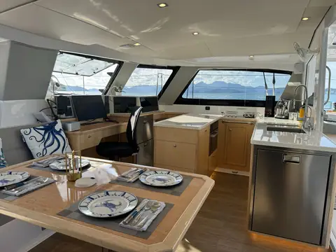 Seawind 1370 saloon with dinette, nav station and galley under wraparound windows