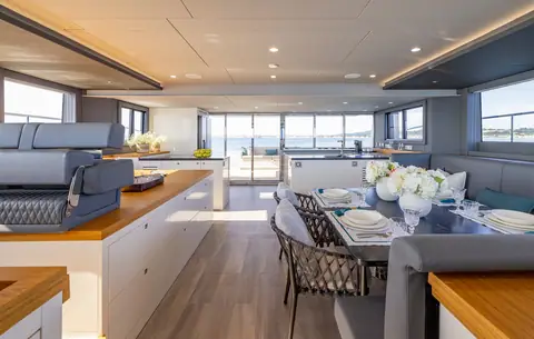 Silent 60 saloon with galley counter, dining table and aft doors to the cockpit