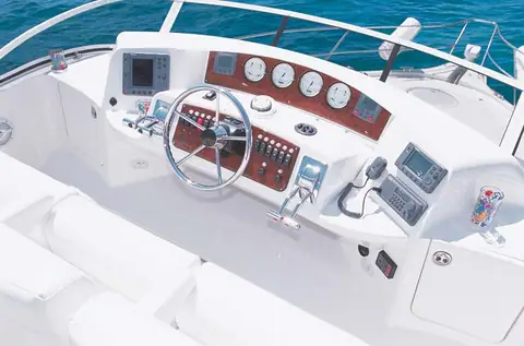Silverton 39 Motor Yacht flybridge helm with burl dash panel, gauges and wheel