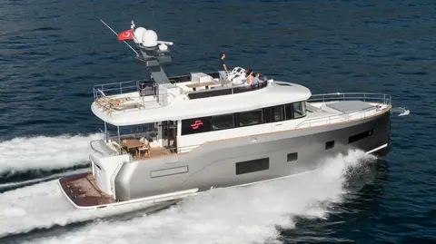 Sirena 58 flybridge yacht with a silver hull running at speed seen from above