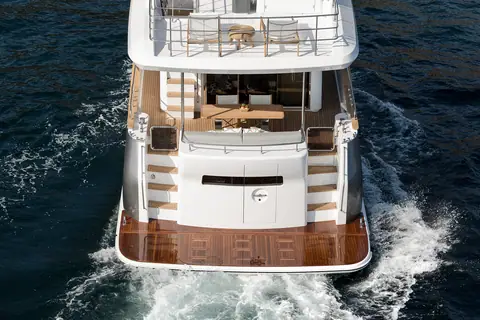 Sirena 58 seen from astern while running, showing the swim platform, cockpit and flybridge