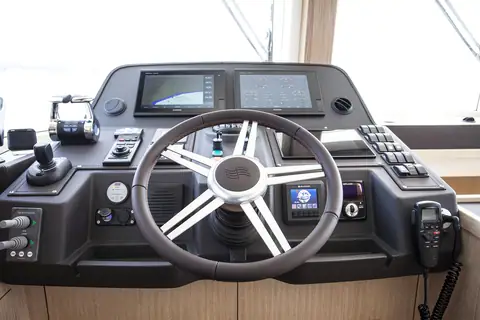 Sirena 58 lower helm with a leather wheel, twin chart displays and engine controls
