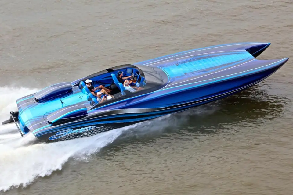 Skater 388 catamaran with a blue paint scheme running fast across calm water