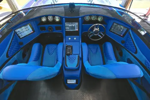 Skater 388 cockpit with blue quilted bolster seats and a digital dash