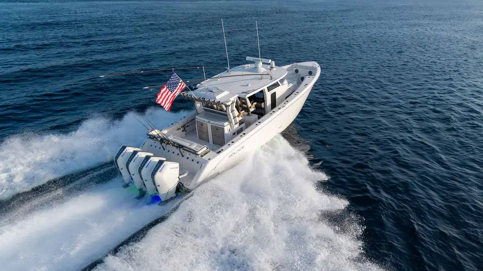 Solace 42CS seen from the stern quarter at speed with quad outboards on the transom