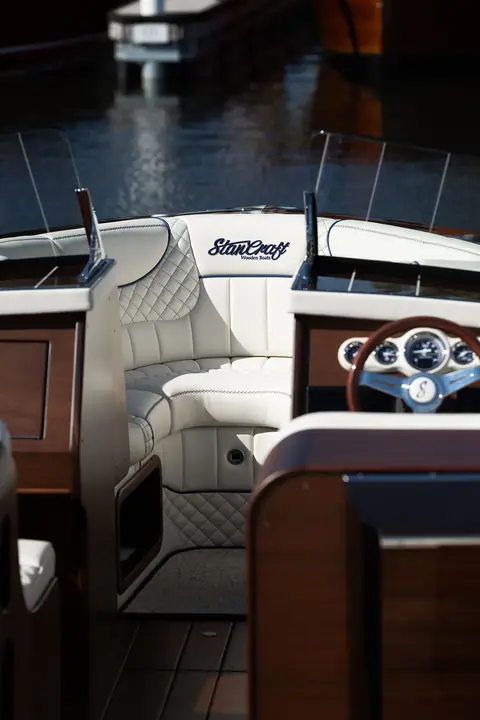 StanCraft 260 Rivelle cockpit with white quilted upholstery, wood dash and chrome gauges
