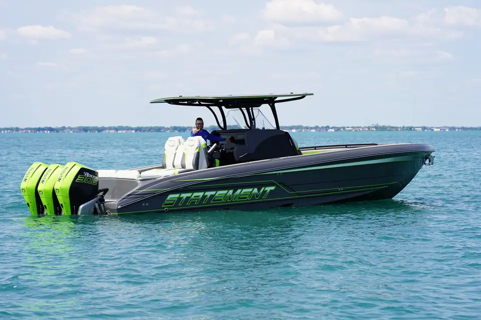 Statement 350 Open cruising on turquoise water with triple green Mercury outboards