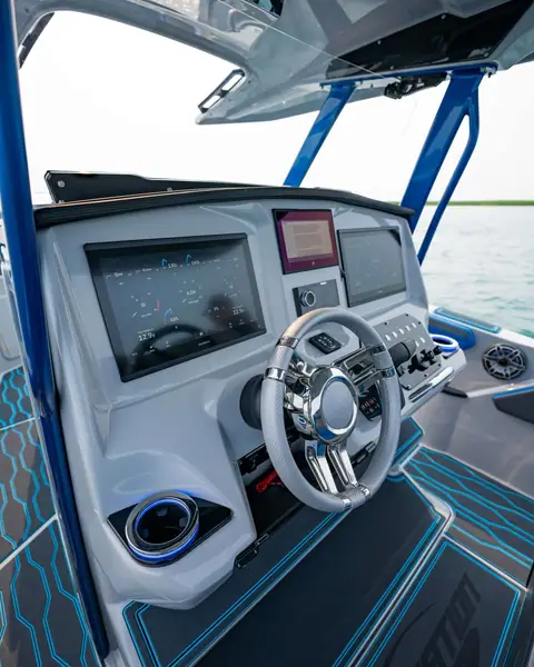 Sunsation 32 CCX helm dash with twin screens, sport wheel and blue accent stitching