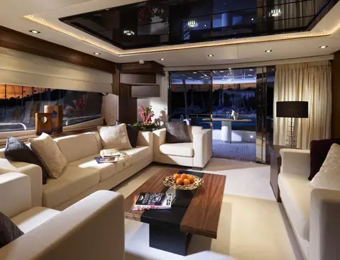 Main salon of the Sunseeker 80 Yacht with cream sofas and walnut joinery