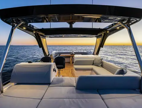 Flybridge of the second generation Sunseeker Manhattan 55 with sun pad, helm and dinette under the hardtop