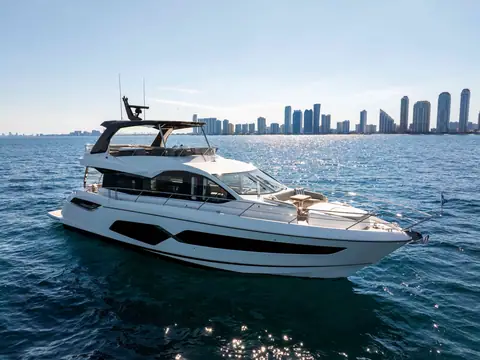 Sunseeker Manhattan 68 cruising slowly off Miami, seen from the bow quarter