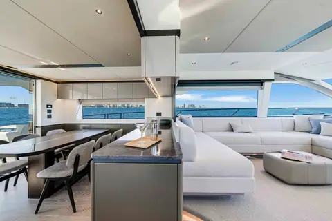 Sunseeker Manhattan 68 main deck salon with dining table, galley island and sofa