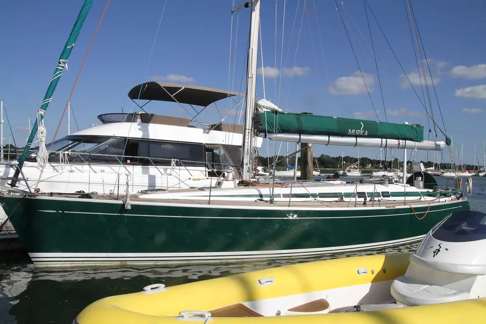 Frers-designed Swan 48 with a dark green hull in a marina