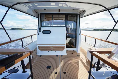 Targa 32 aft cockpit with teak decking, side walkways and a canvas top over the wheelhouse door
