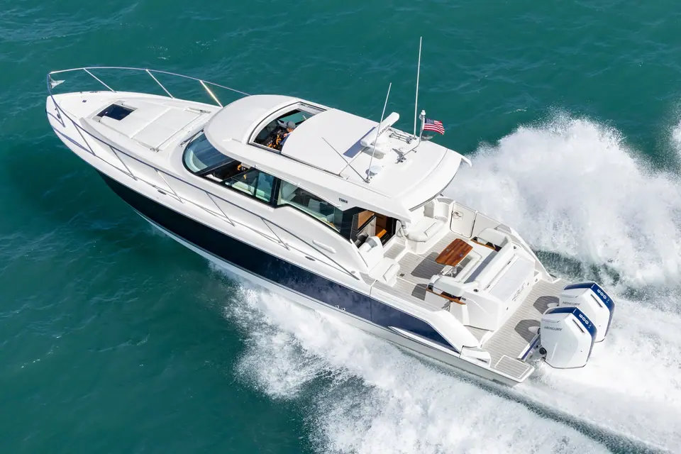 Aerial view of the Tiara 43 LE at speed showing the hardtop, open sunroof and twin Mercury outboards