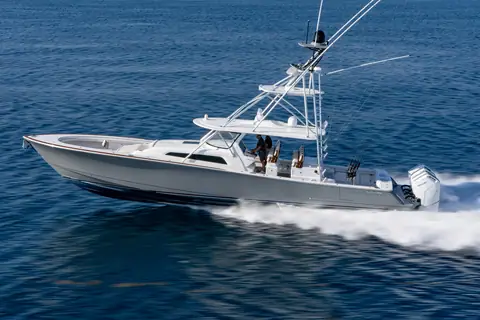 Valhalla V55 center console with a tuna tower running at speed in profile on open water