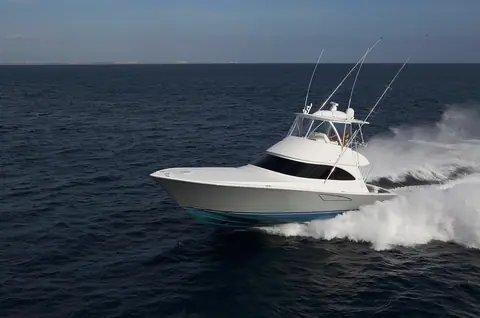 Viking 48 Convertible flybridge sportfisherman running at speed in profile with outriggers up
