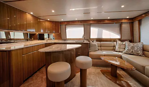 Viking 52 Convertible salon with galley island, round stools and an L shaped settee