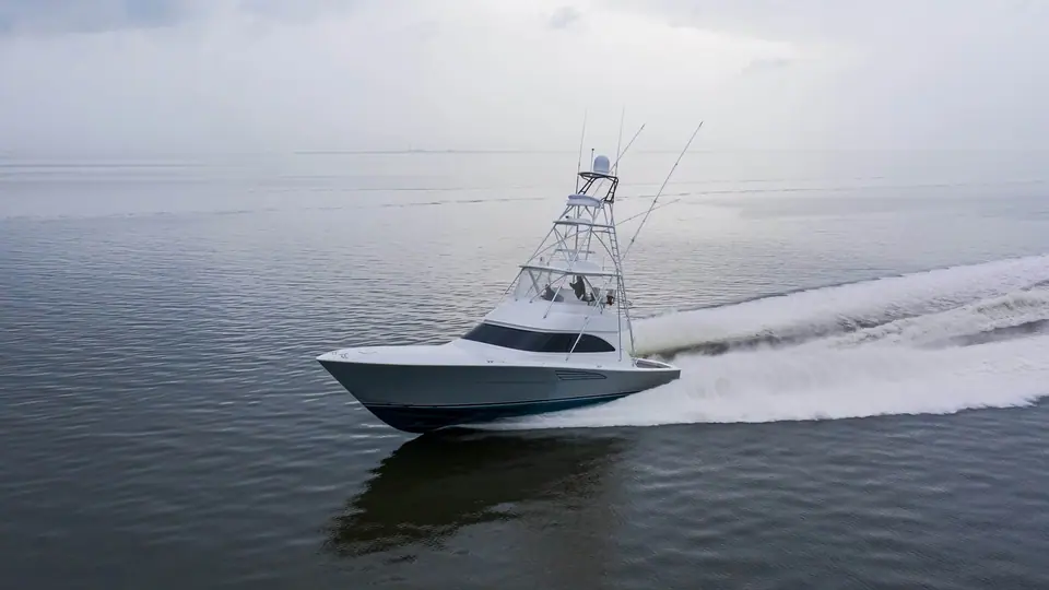 Viking 54 Convertible cruising across flat calm water with a long wake behind