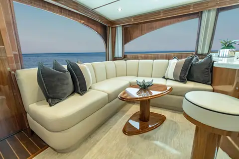 Viking 54 Convertible salon with a cream leather U shaped settee and high gloss wood