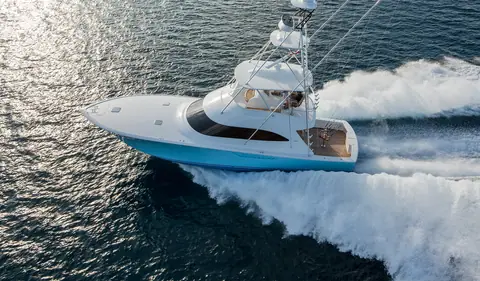 Viking 55 Convertible crossing sunlit water at speed, seen from the stern quarter