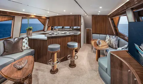 Viking 58 Convertible salon with galley island, bar stools, dinette and walnut joinery