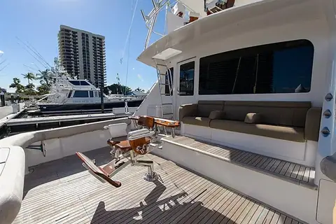 Teak cockpit of a 2008 Viking 60 Convertible with a fighting chair and mezzanine seating