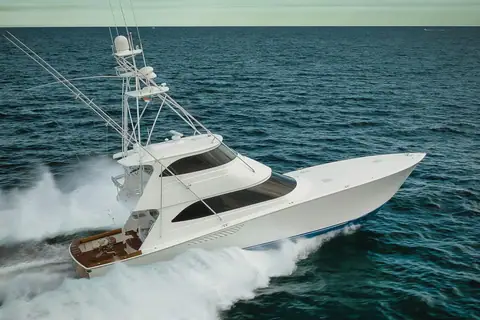 Viking 70 Enclosed Bridge running at speed with a tuna tower and teak cockpit visible