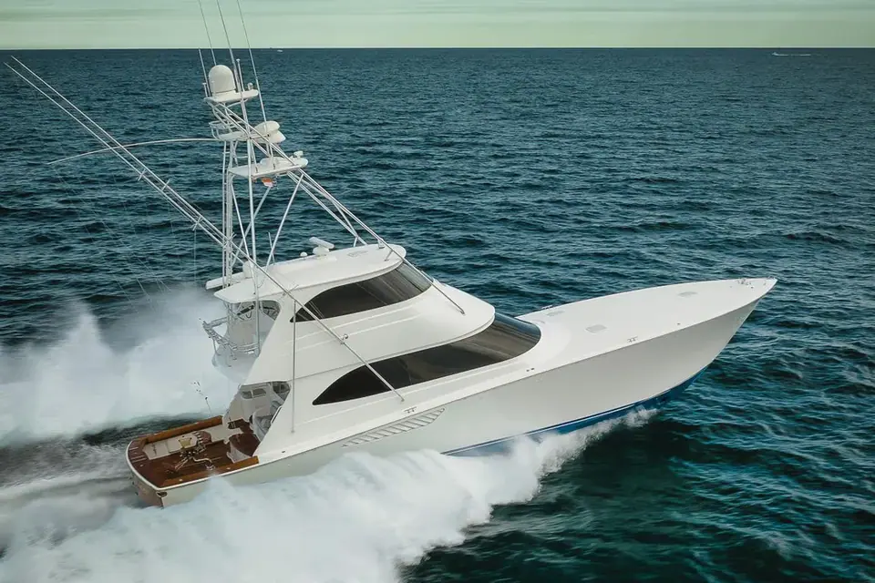 Viking 70 Enclosed Bridge running at speed with a tuna tower and teak cockpit visible