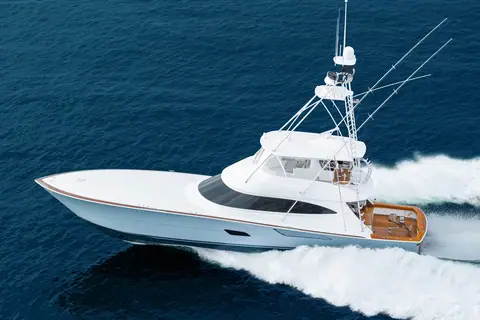 Viking 82 Convertible running at speed on open water with its tuna tower and outriggers