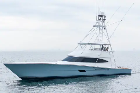 White Viking 82 Convertible sportfish yacht in profile underway on a calm gray sea