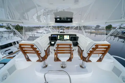 Viking 90 Convertible flybridge with three teak helm chairs facing the center console