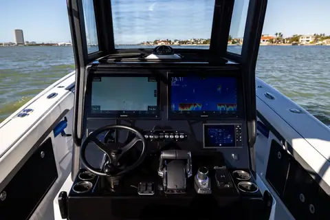 Yellowfin 36 Offshore helm with twin large displays, wheel and throttles behind the windshield
