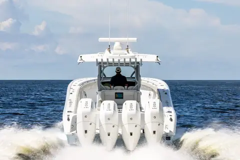 Stern view of a Yellowfin 39 Offshore running with quad outboards under the T top