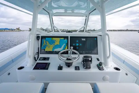 Yellowfin 42 Offshore helm with two large displays, wheel and throttles under the hardtop